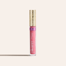 Load image into Gallery viewer, Pink sheer silk lip oil in a clear tube with a gold decorative cap standing upright
