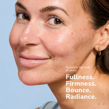 Load image into Gallery viewer, Close-up of a smiling woman with clear skin and freckles showing skincare results
